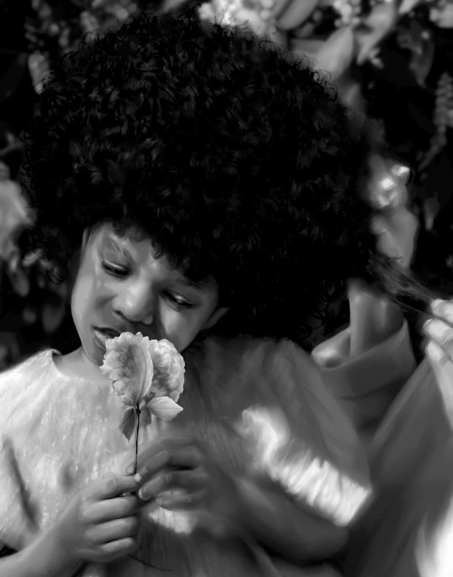Black and white photo of a child holding flowers with another person's arm around them.