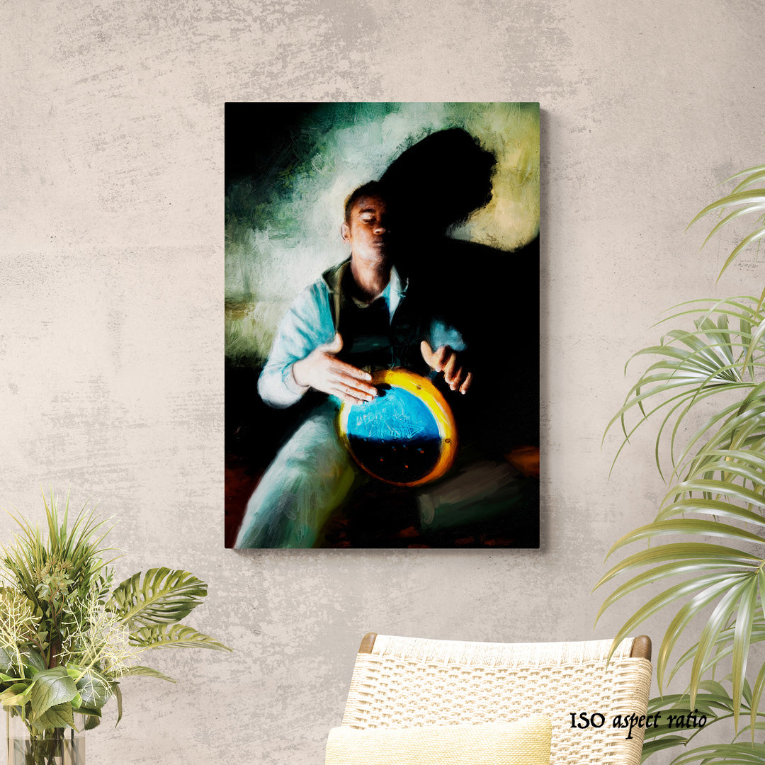 Framed artwork of a person playing a drum against a tan colored wall.